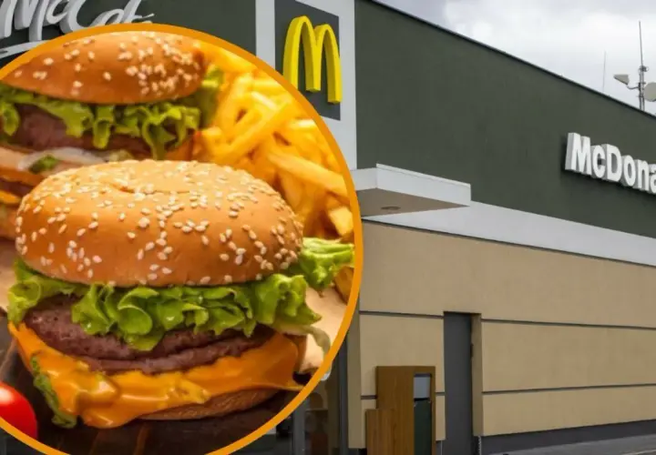 Cheeseburger i frytki na tle budynku McDonald's.